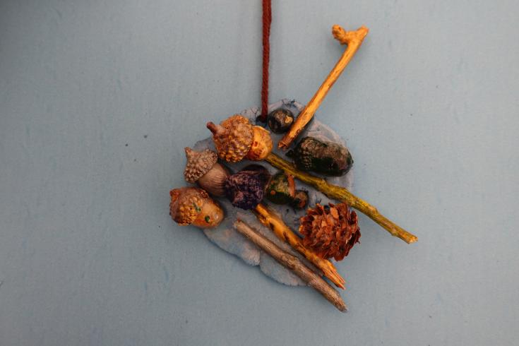 Clay mobile with sticks and acorns.
