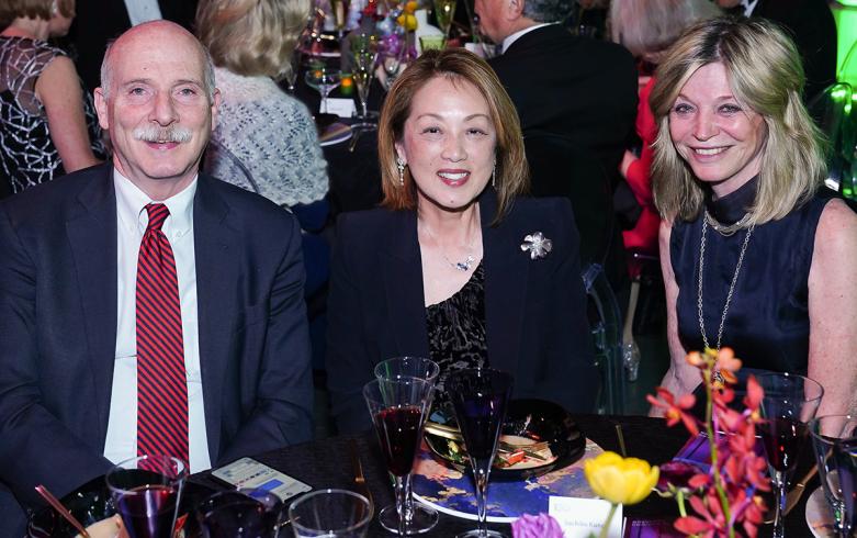 Three people sitting at a table at a Gala