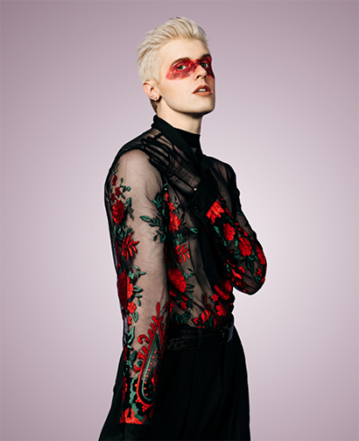 Photo of Bryce Bowyn wearing a sheer black shirt with red flowers