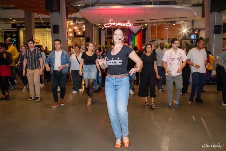 Someone leading the group in a dance lesson