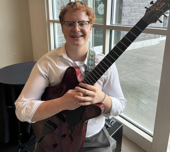 Ben Scott holding a guitar