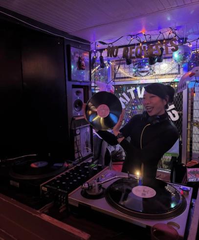 DJ $et in front of a DJ set up