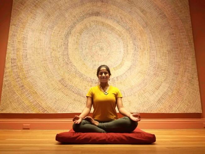 Aparna Sadananda meditating in the Marking the Infinite galleries