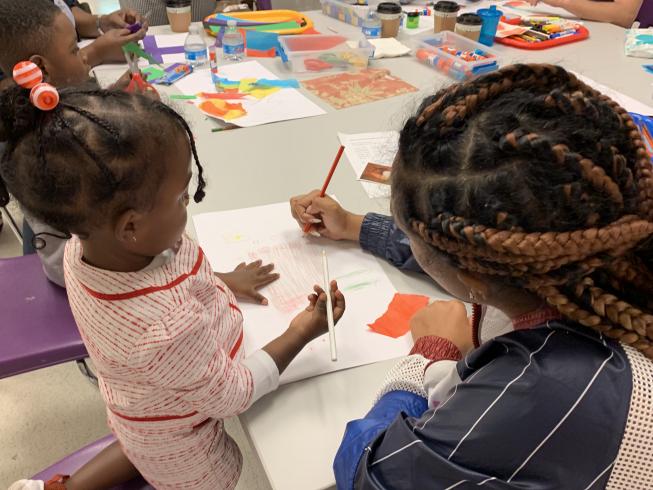 Families creating art during the AppleTree workshop