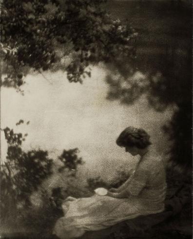 Woman seated under tree
