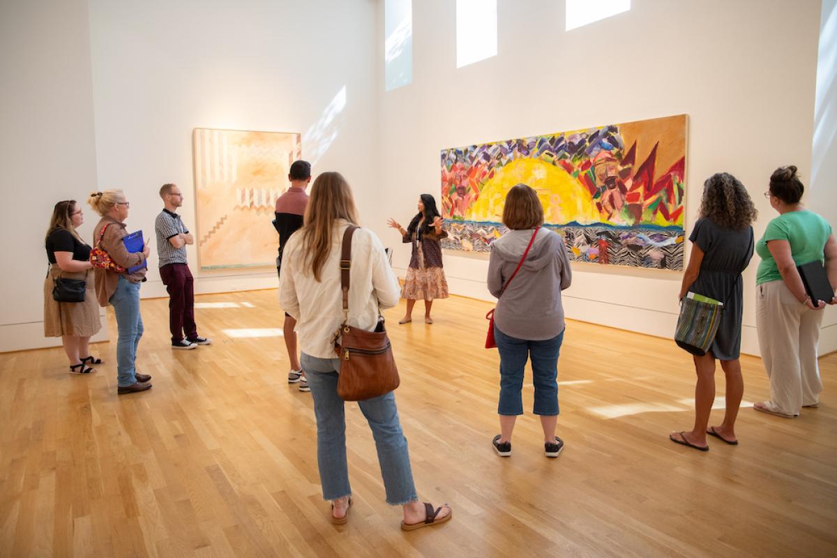 Educators observing a large painting, led by a Phillips educator 