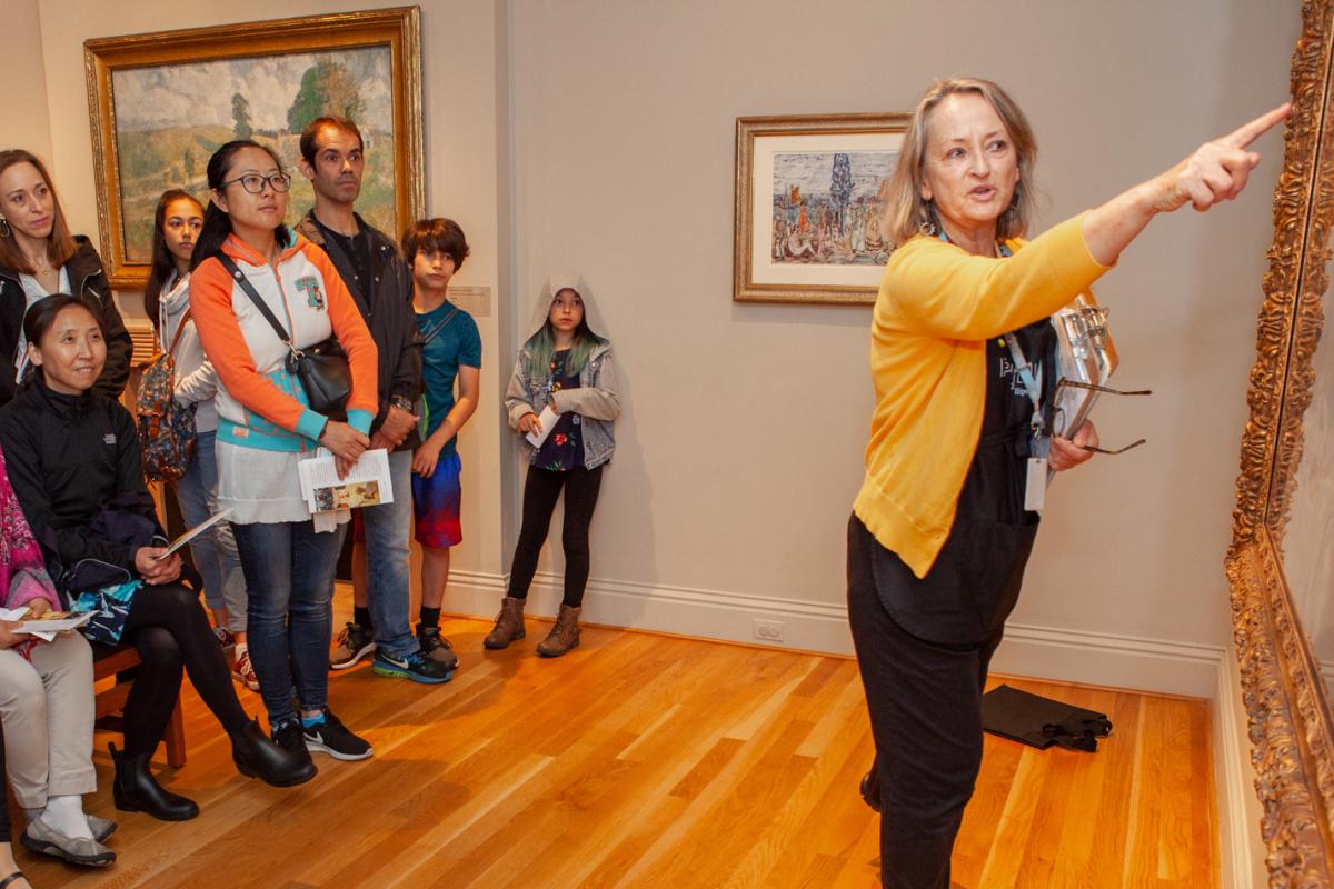 Donna giving a gallery talk to a large group of guests
