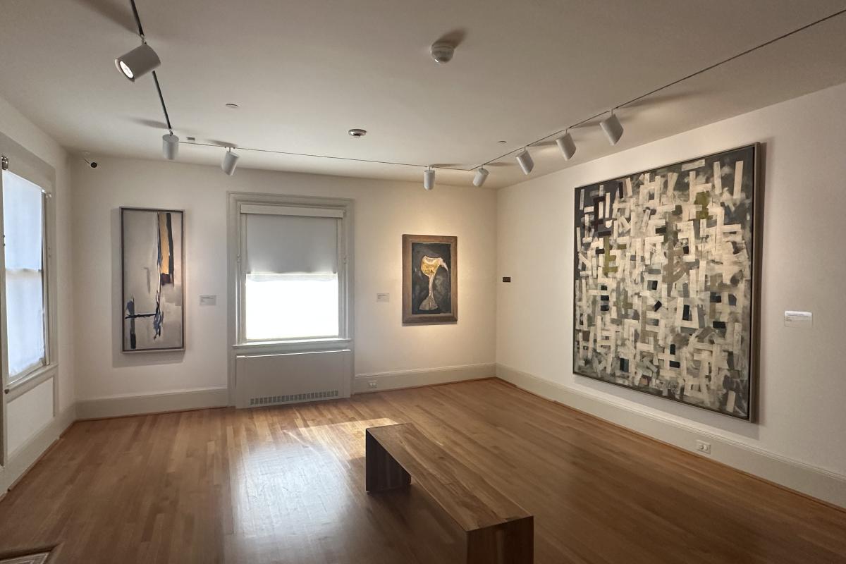 Installation photo of Gallery D with three artworks on the wall and large windows