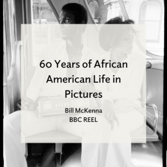 African American couple wearing white suits sitting in the back of a car